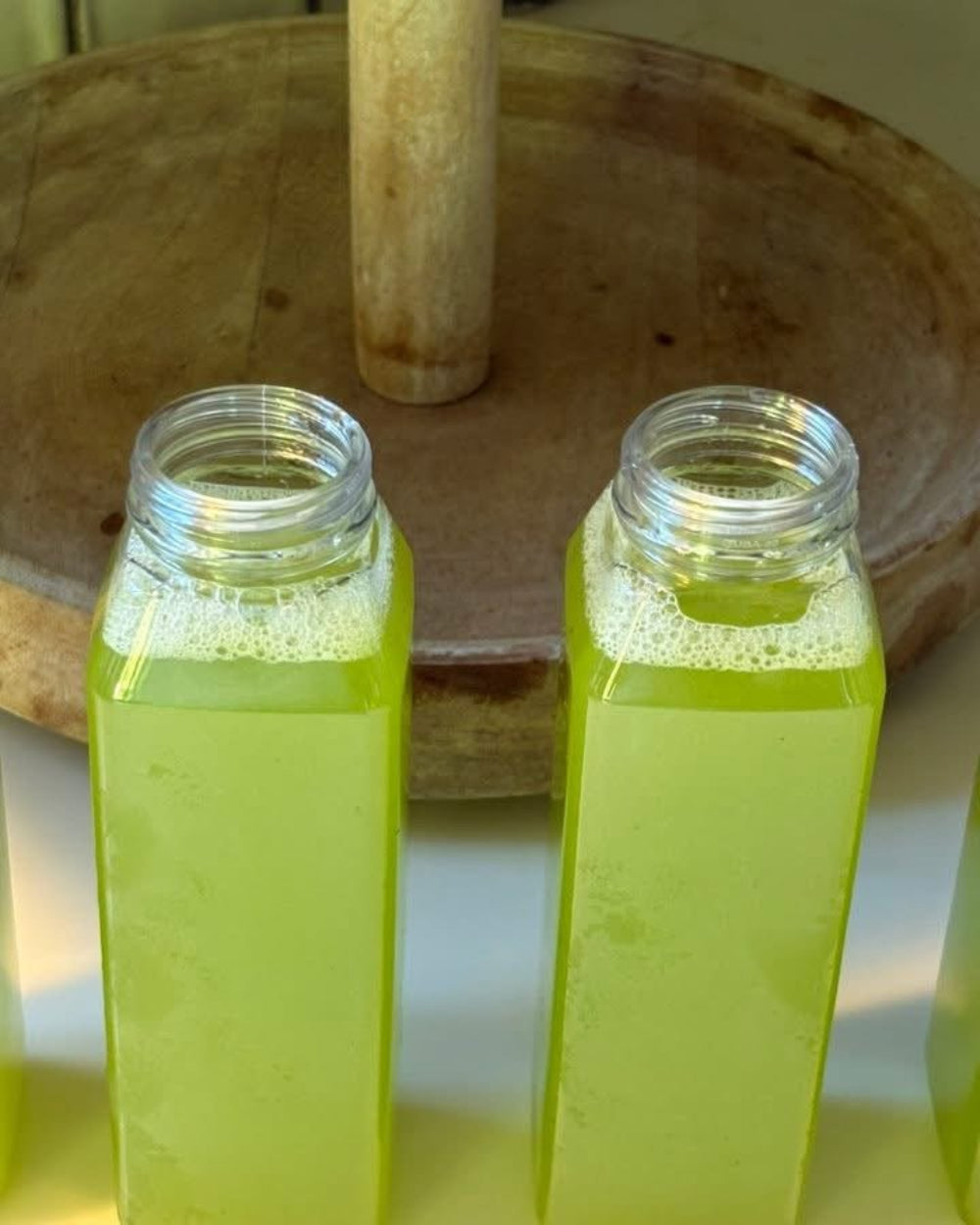 Kae Health Juice bottles filled with fresh green celery juice detox for a natural cleanse