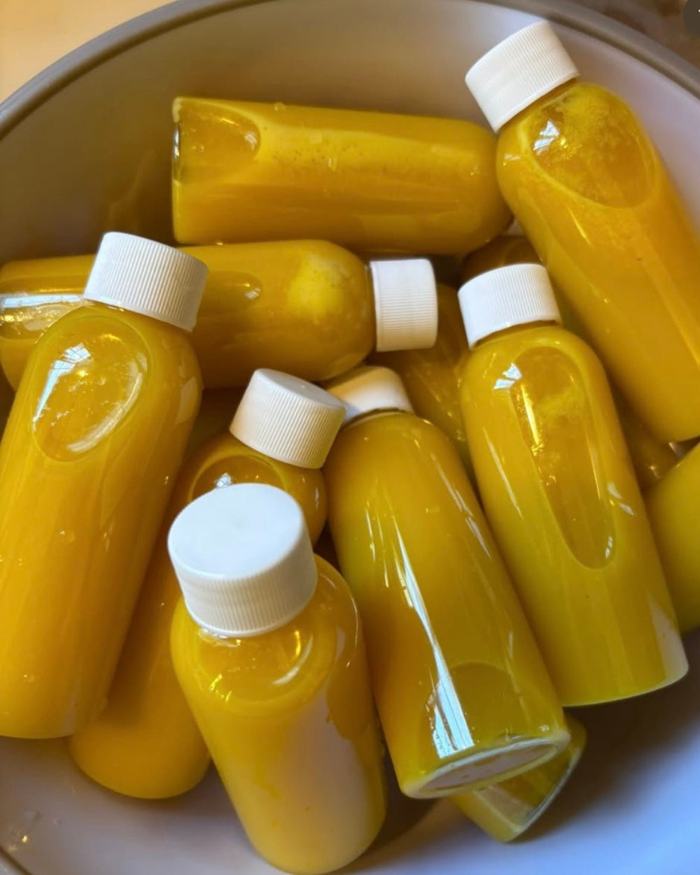 Kae Health Juice bottles filled with yellow ginger shot for ginger shot Detroit delivery