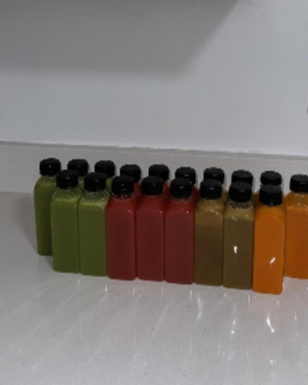 Kae Health Juice bottles in green, red, brown, and orange for three day juice cleanse weight loss